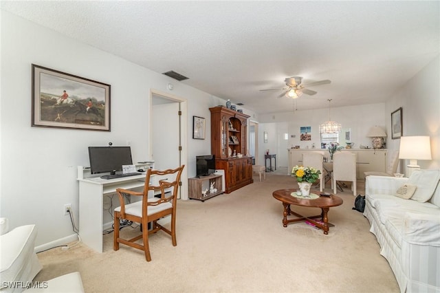 carpeted living room with ceiling fan and a textured ceiling