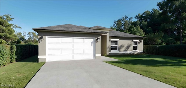 view of front of home with a front yard and a garage