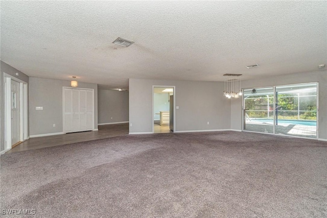 spare room with carpet flooring and a textured ceiling