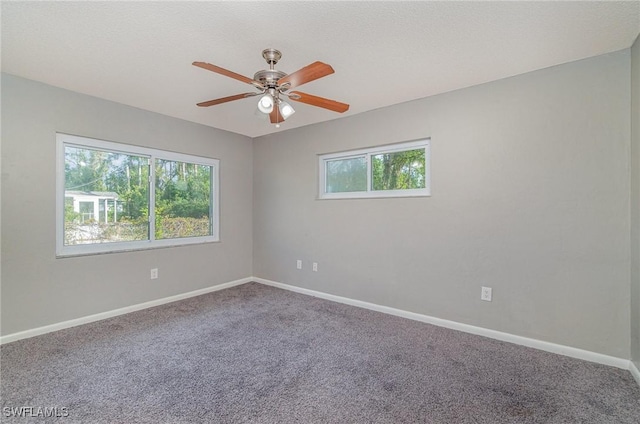 carpeted empty room featuring ceiling fan