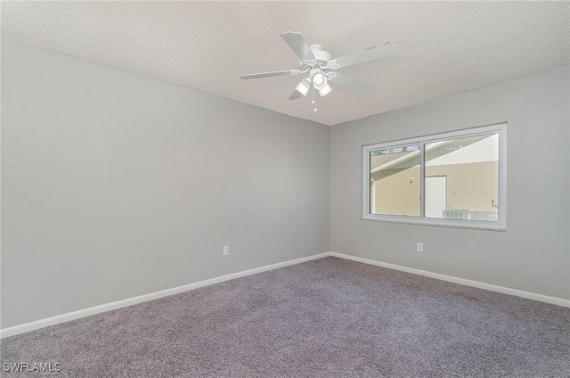 empty room with carpet, ceiling fan, and a textured ceiling