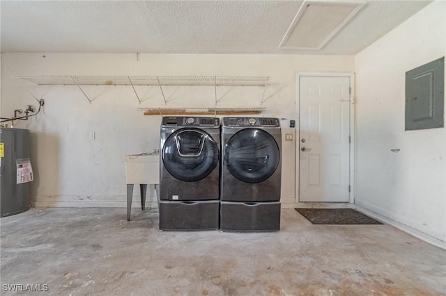 washroom featuring a textured ceiling, electric water heater, electric panel, and washing machine and clothes dryer