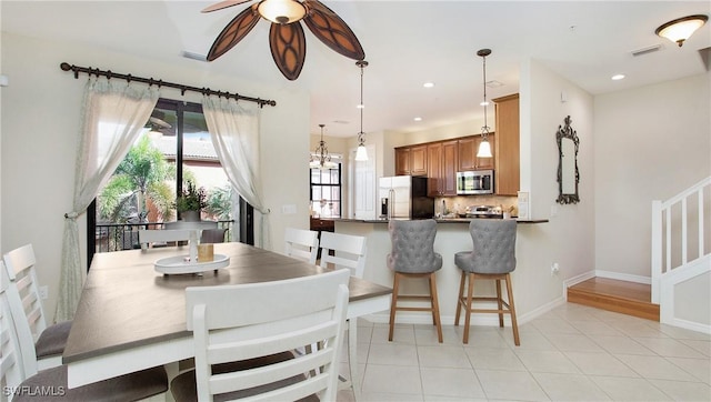 dining room featuring ceiling fan and light tile patterned floors