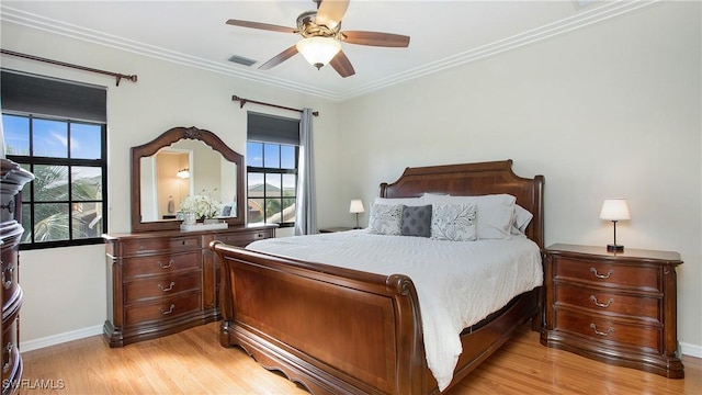 bedroom with ceiling fan, light hardwood / wood-style floors, and crown molding