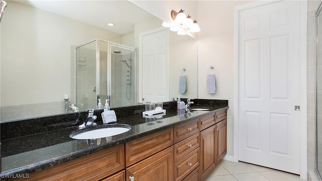 bathroom with tile patterned floors, vanity, and an enclosed shower