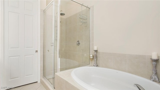 bathroom with tile patterned flooring and independent shower and bath