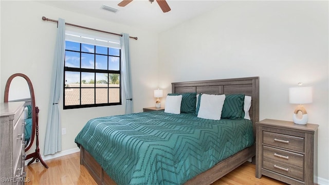 bedroom with ceiling fan and light hardwood / wood-style floors