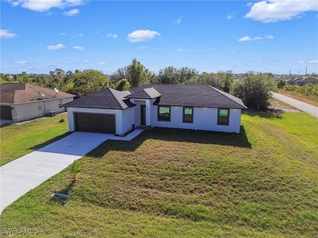 view of front of home featuring a front yard and a garage