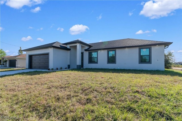 view of front of property featuring a garage and a front lawn