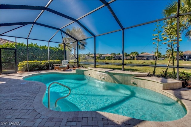 view of pool with pool water feature, a patio, and a lanai