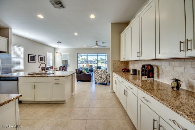 kitchen with dishwasher, plenty of natural light, decorative light fixtures, and sink