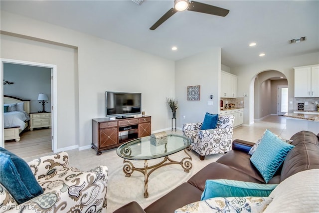 living room with ceiling fan and light hardwood / wood-style floors