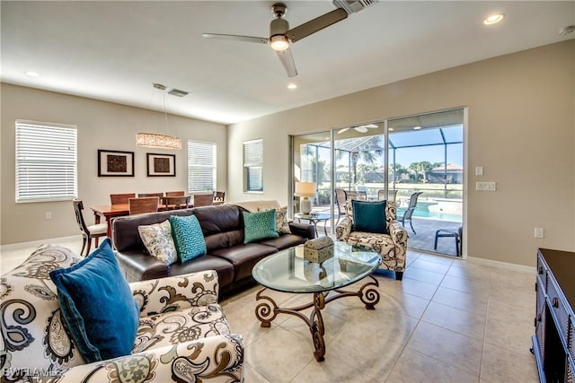 tiled living room with plenty of natural light and ceiling fan