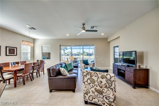 living room featuring ceiling fan and light tile patterned floors