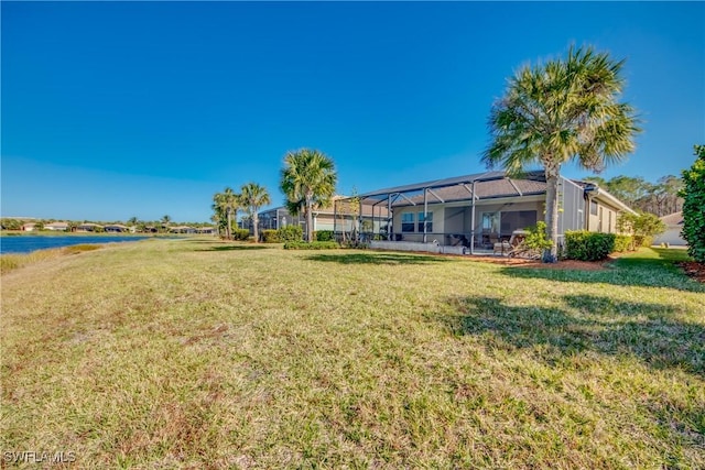 view of yard featuring a lanai and a water view