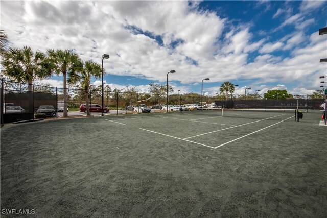 view of tennis court featuring basketball hoop