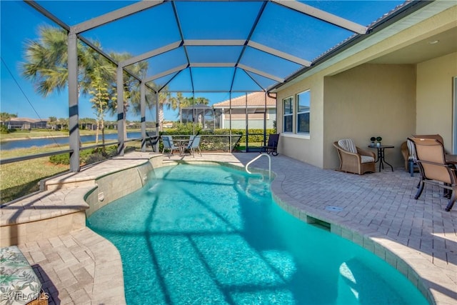 view of swimming pool featuring glass enclosure and a patio area