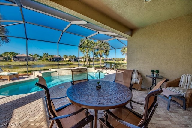 view of pool with glass enclosure and a patio area