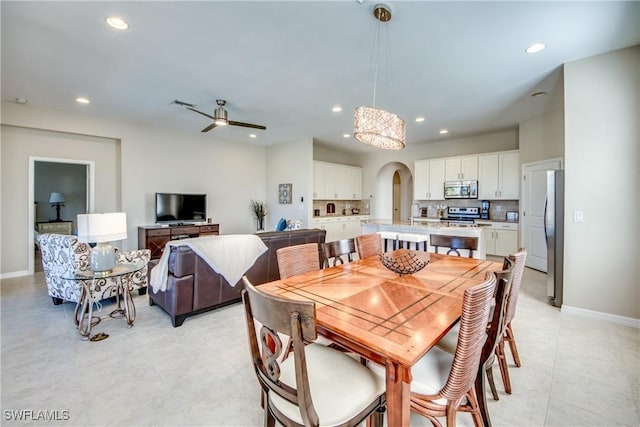 tiled dining area featuring ceiling fan