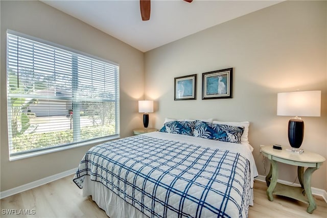 bedroom with multiple windows, ceiling fan, and light hardwood / wood-style flooring