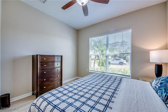 bedroom featuring light wood-type flooring, ceiling fan, and lofted ceiling