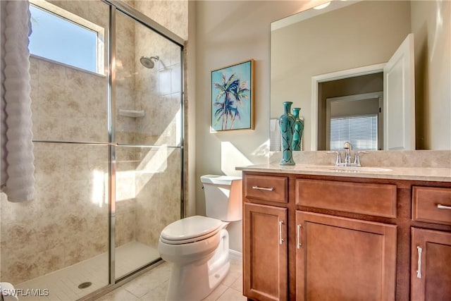 bathroom with toilet, vanity, tile patterned floors, and a shower with shower door