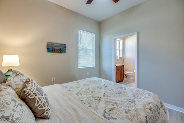 bedroom with ensuite bathroom, ceiling fan, and light hardwood / wood-style floors