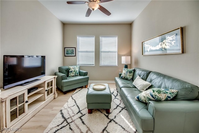 living room featuring ceiling fan and light hardwood / wood-style floors