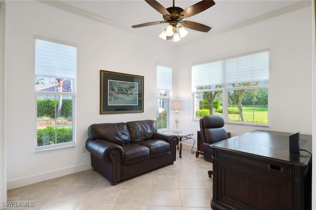 home office with ceiling fan, crown molding, and light tile patterned floors