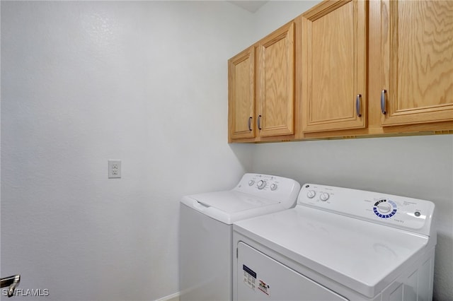 laundry room featuring cabinets and washing machine and clothes dryer