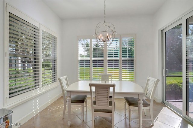 dining room with light tile patterned floors and a notable chandelier