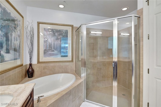 bathroom featuring vanity and separate shower and tub