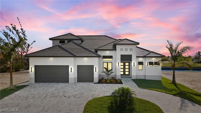 view of front facade featuring french doors and a garage