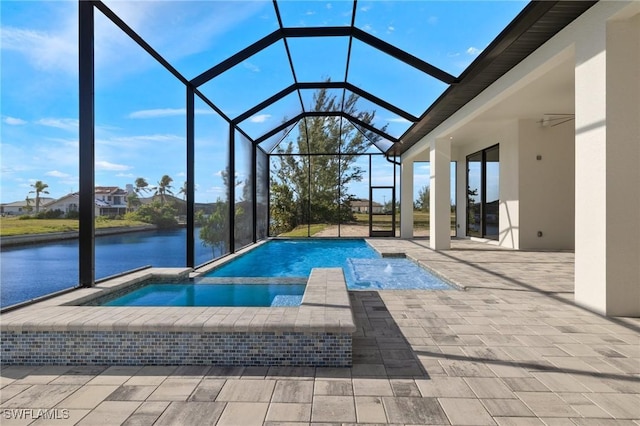 view of swimming pool with a patio area, a lanai, an in ground hot tub, and a water view