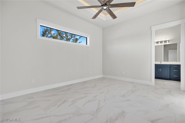 unfurnished bedroom featuring ceiling fan and ensuite bath