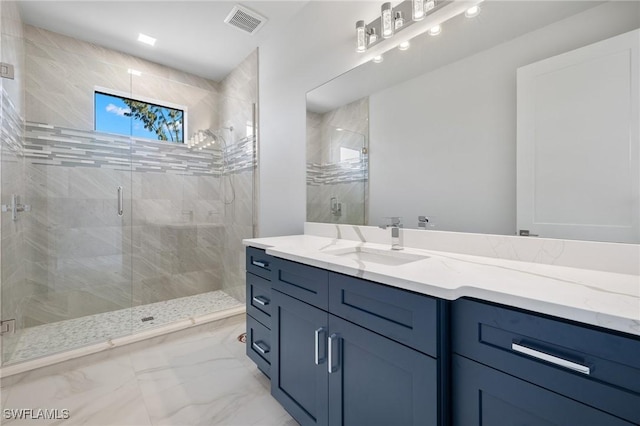 bathroom featuring vanity and an enclosed shower