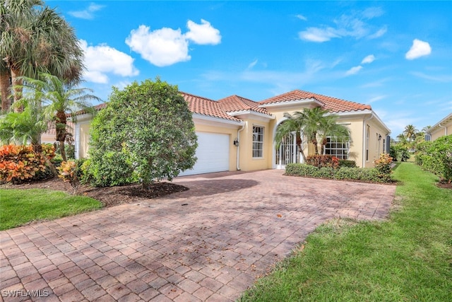 mediterranean / spanish-style house with a garage