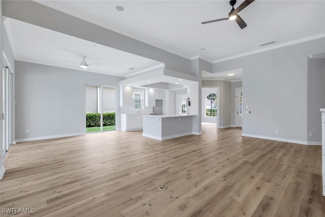 unfurnished living room featuring ceiling fan, crown molding, and light hardwood / wood-style flooring