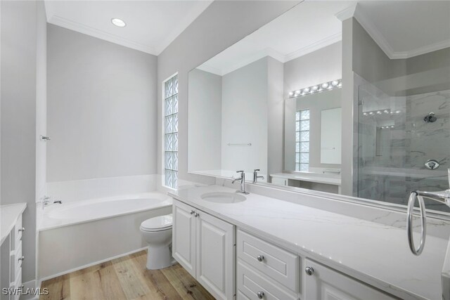 full bathroom with crown molding, hardwood / wood-style floors, shower with separate bathtub, toilet, and vanity