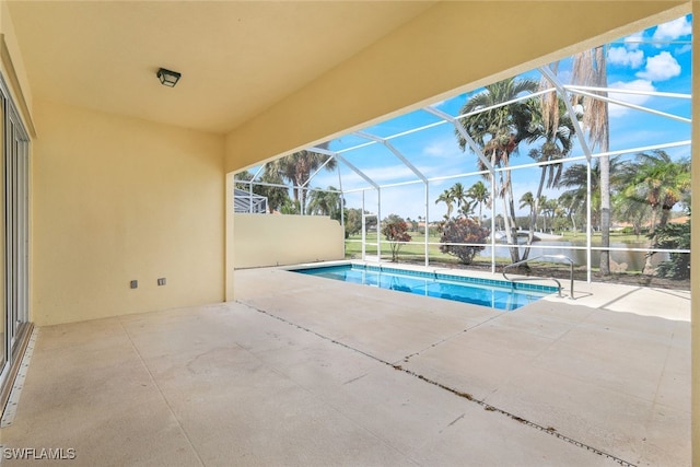 view of swimming pool featuring a lanai and a patio area