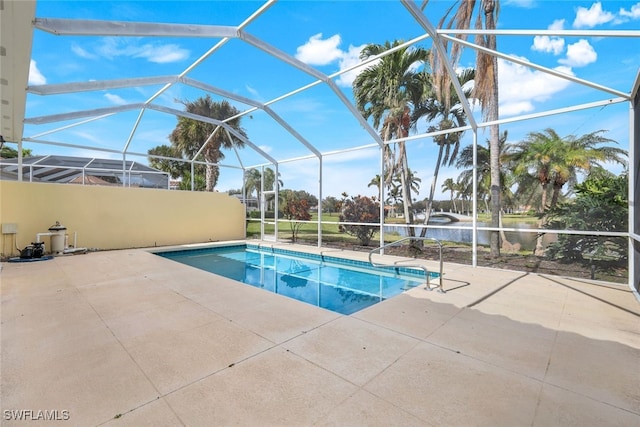 view of swimming pool with a lanai, a patio area, and a water view