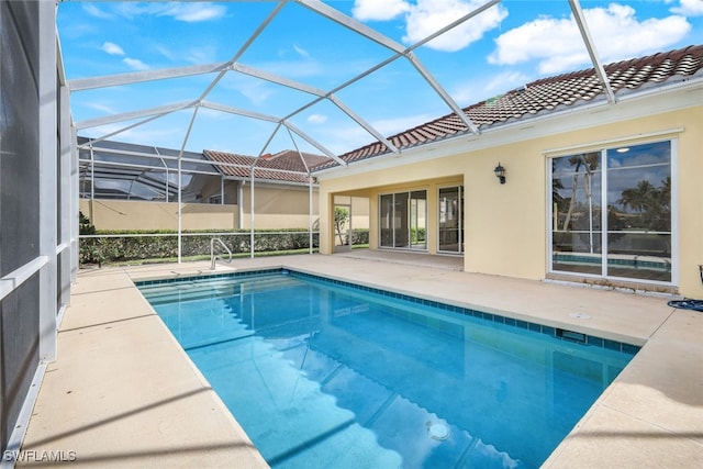 view of swimming pool featuring a patio area and a lanai