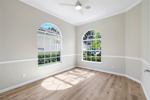 empty room with ceiling fan, ornamental molding, and light wood-type flooring