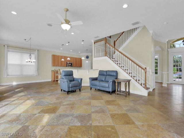 living room featuring ceiling fan with notable chandelier and crown molding