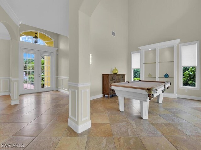 recreation room featuring a high ceiling, french doors, and billiards