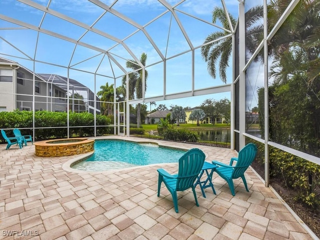 view of pool featuring glass enclosure, a water view, and a patio