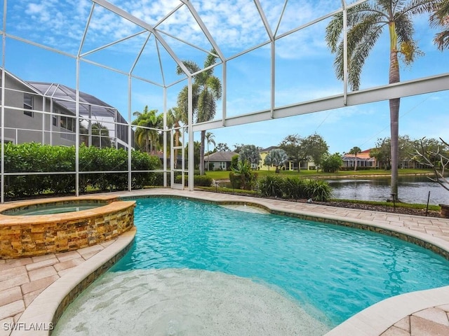 view of pool with glass enclosure, a water view, and an in ground hot tub