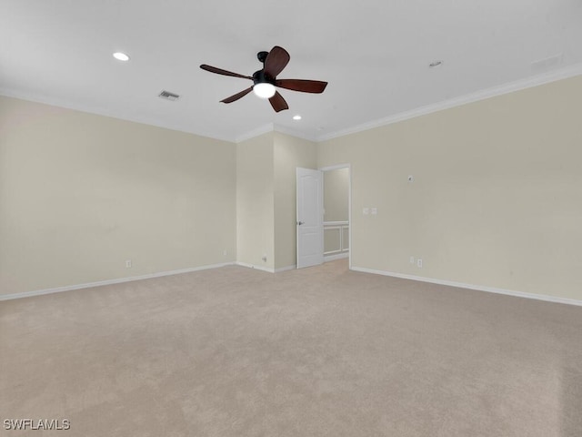 carpeted empty room featuring ceiling fan and crown molding