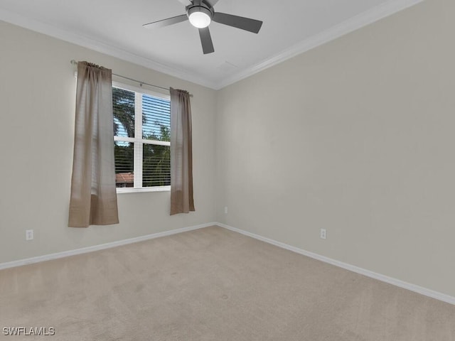 unfurnished room featuring light colored carpet, ceiling fan, and crown molding