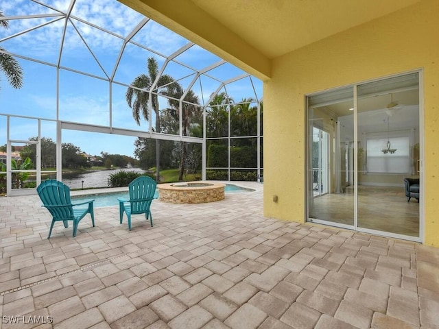 view of patio / terrace featuring a swimming pool with hot tub and a lanai